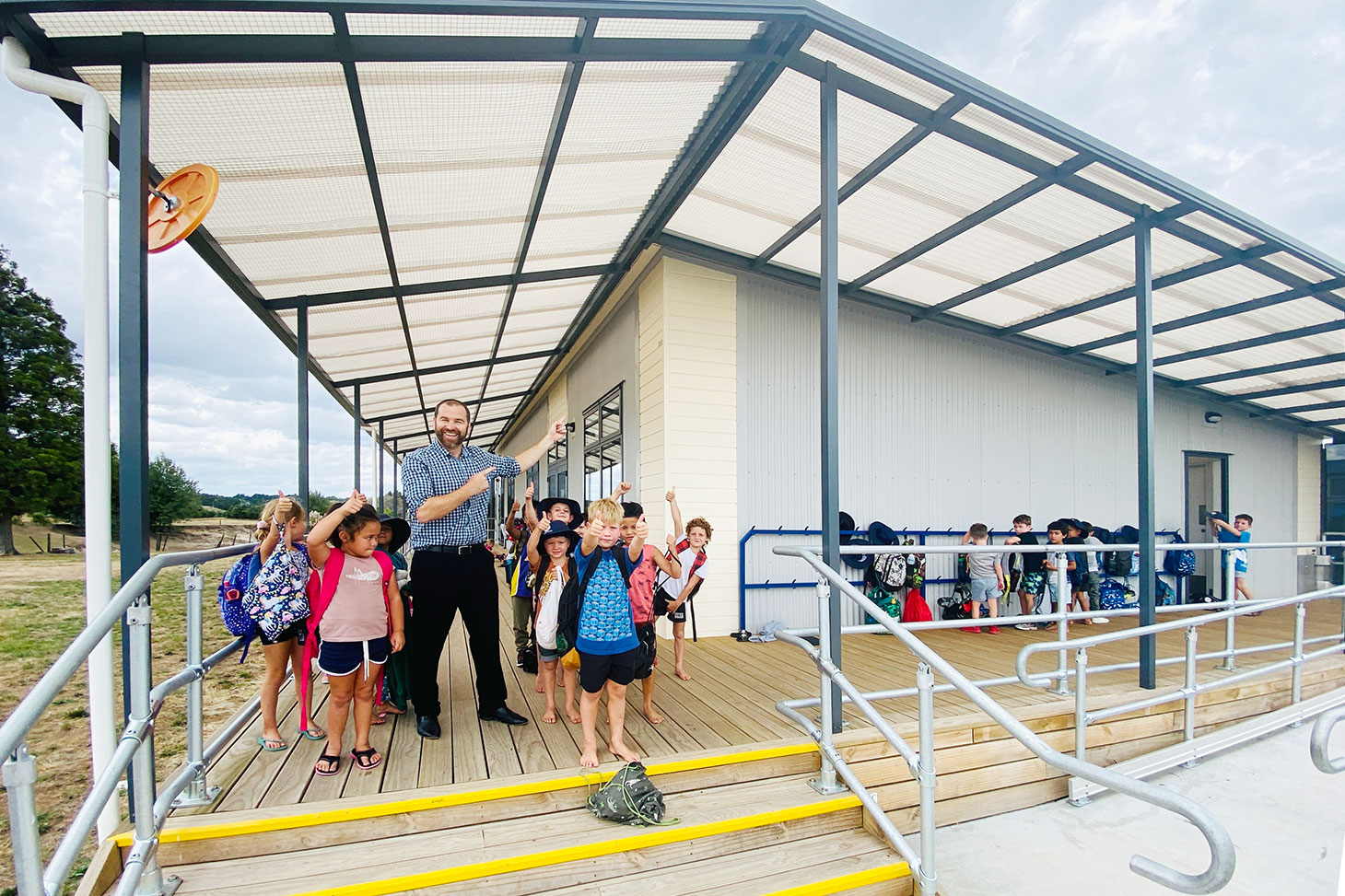 Principal Jonathan Wright with Horotiu Primary School junior students in their new learning space.